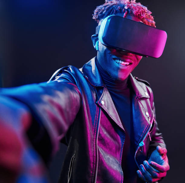 istock Virtual reality experience. Futuristic neon lighting. Young african american man in the studio 1326068709
