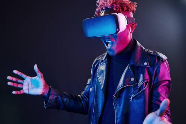 istock Virtual reality experience. Futuristic neon lighting. Young african american man in the studio 1326068732
