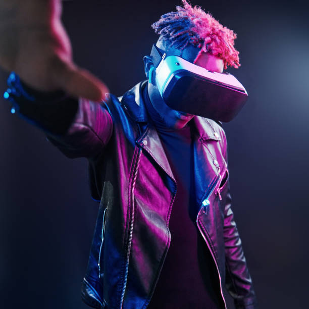 istock Virtual reality experience. Futuristic neon lighting. Young african american man in the studio 1326068733