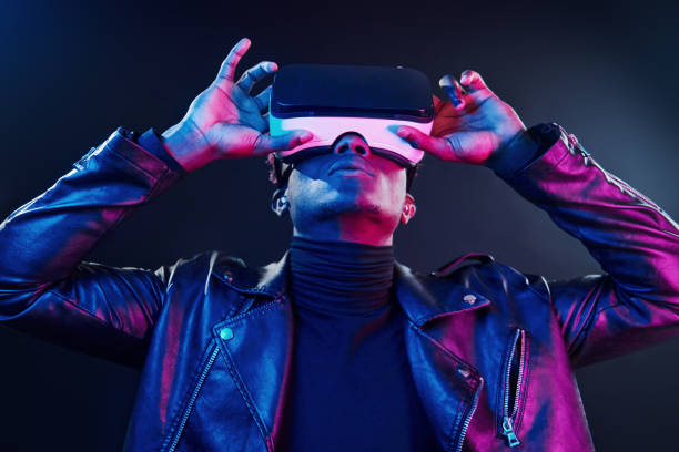 istock Virtual reality experience. Futuristic neon lighting. Young african american man in the studio 1326068779