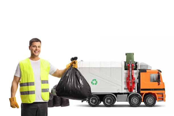 istock Garbage man with a plastic bag and a garbage truck 1326068852