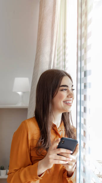 istock Smiling business woman using phone in office. 1326069664