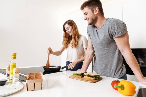 istock Smiling young couple cooking lunch 1326069681