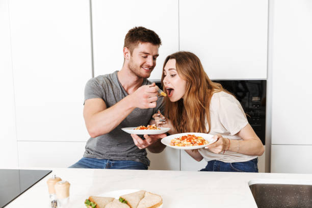 istock Smiling young couple eating breakfast together 1326069892