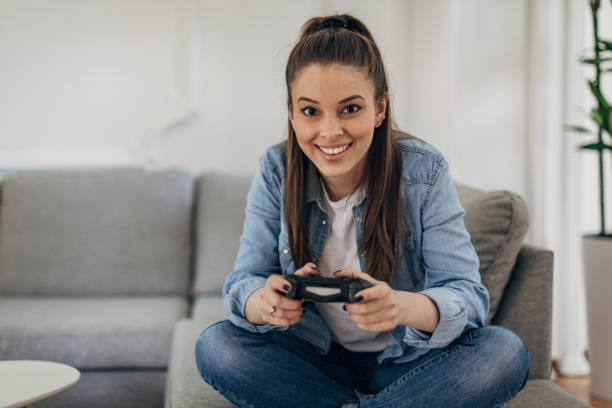 istock Woman playing video games 1326070010