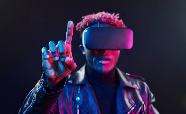istock Virtual reality experience. Futuristic neon lighting. Young african american man in the studio 1326070083
