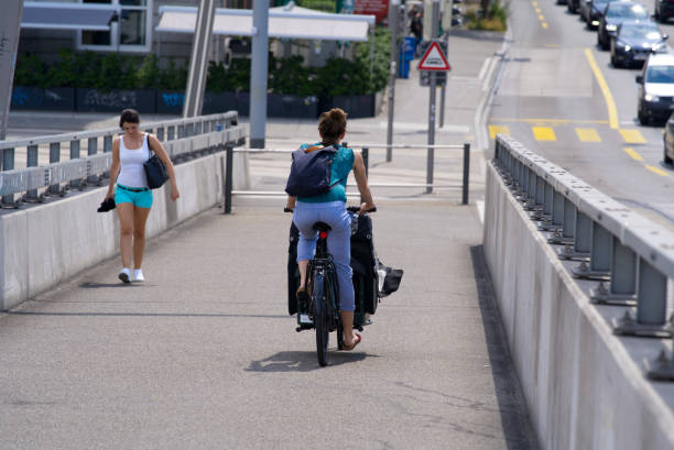two women on pavement of bridge at zurich. - parents children cargo bike bildbanksfoton och bilder