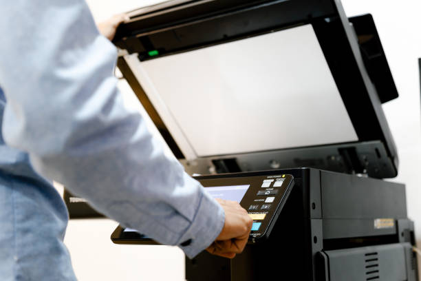 istock Bussiness man Hand press button on panel of printer, printer scanner laser in office copy machine supplies start concept. 1326070128