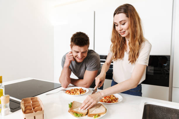 istock Smiling young couple cooking lunch together 1326070160