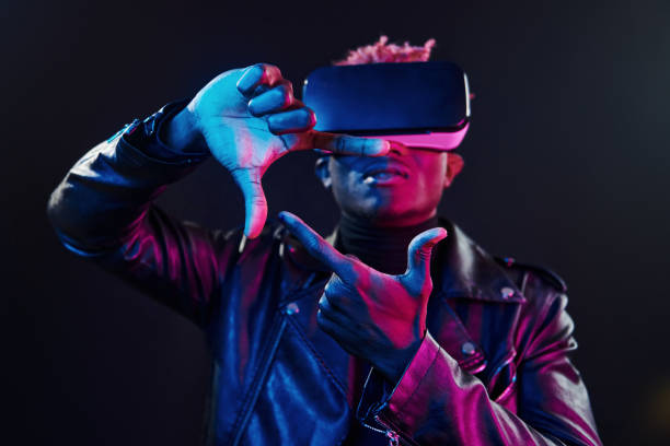 istock Virtual reality experience. Futuristic neon lighting. Young african american man in the studio 1326070185