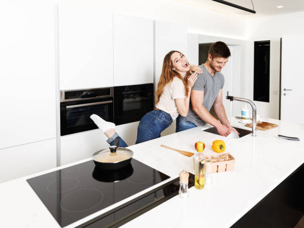 istock Cheerful young couple cooking breakfast 1326070548