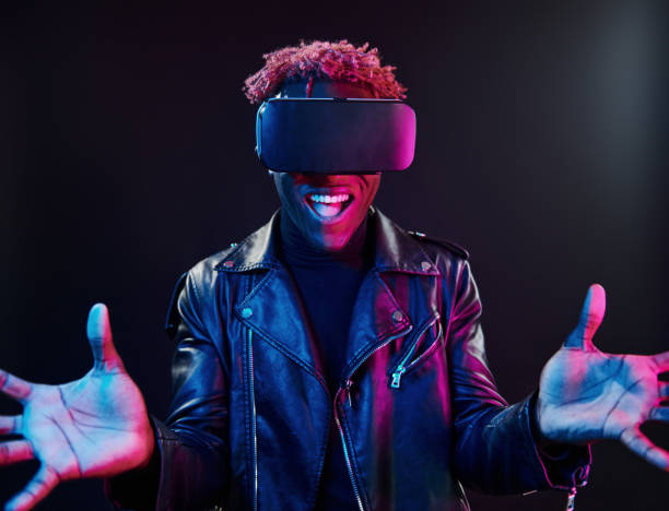 istock Virtual reality experience. Futuristic neon lighting. Young african american man in the studio 1326070693