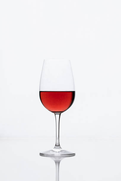 istock Red wine glass glossy white background with reflection. Simple minimalist image 1326071240
