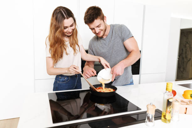 istock Happy young couple cooking breakfast 1326072076