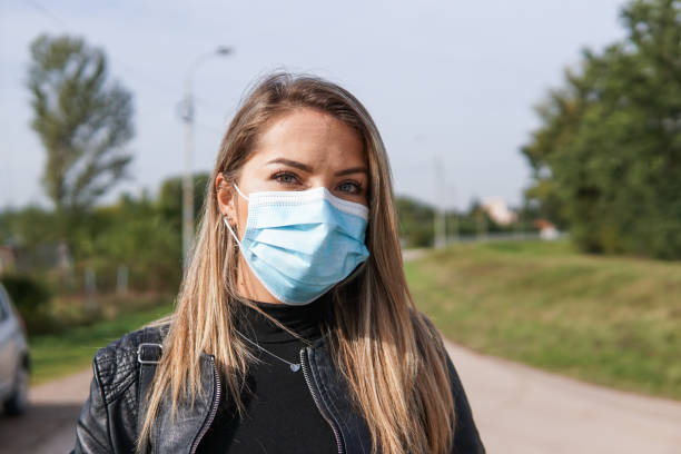 istock Woman with face protective mask. Covid-19 protection. 1326072852