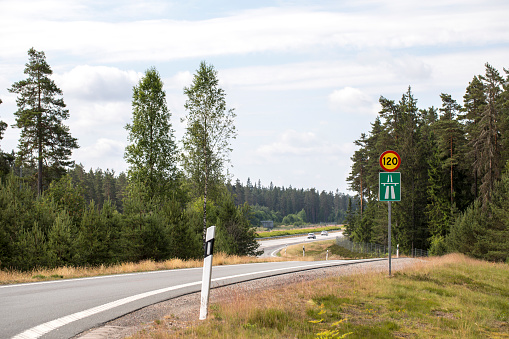 road sign shows the start of the freeway and the current speed limit in sweden