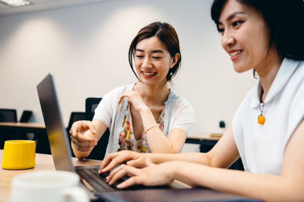 istock Two Professional Asian businesswoman working on computer in office. 1326075020