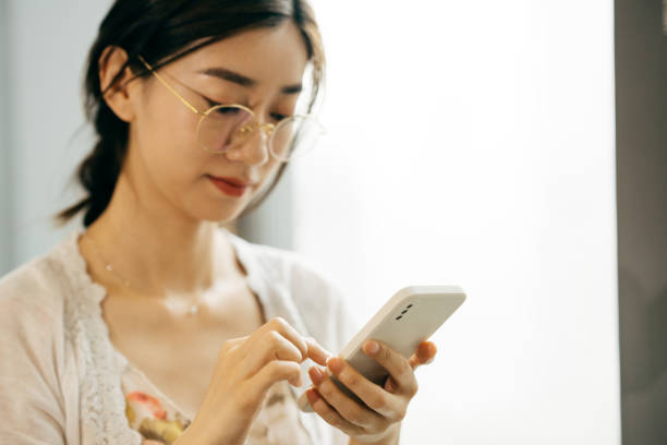 istock Asian young businesswoman using a smartphone in office. 1326075613