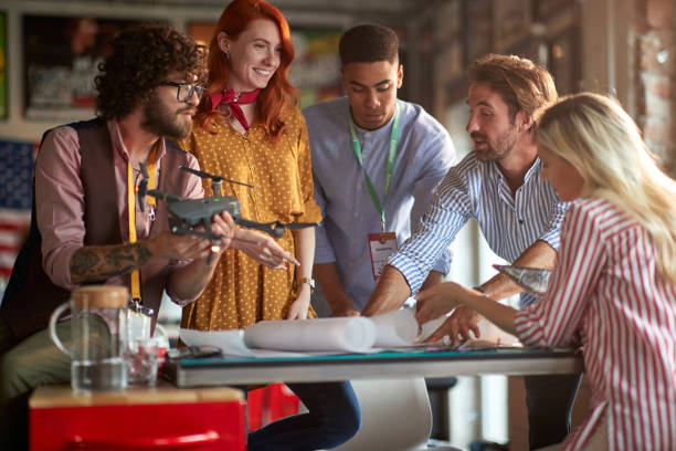istock A group of young creative people in the office are discussing a plan how they will use a drone. Employees, office, work 1326076359