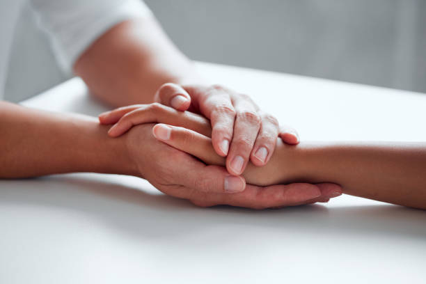 istock Closeup shot of two unrecognisable people holding hands 1326076537