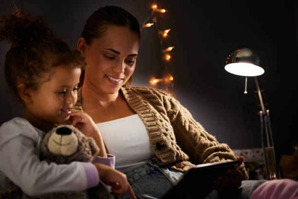istock Shot of a young mother and daughter using a digital tablet before bed 1326076566