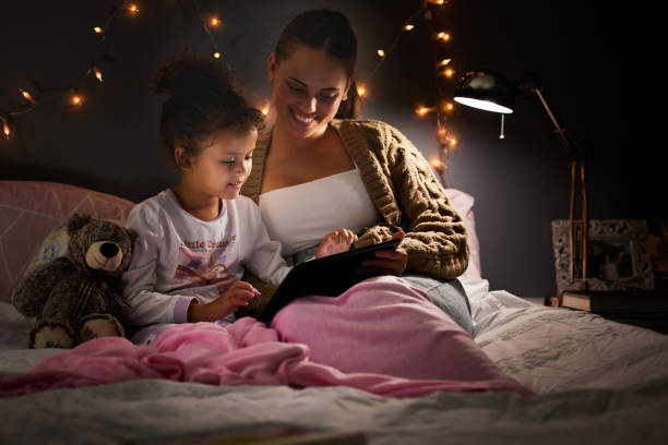 istock Shot of a young mother and daughter using a digital tablet before bed 1326076641