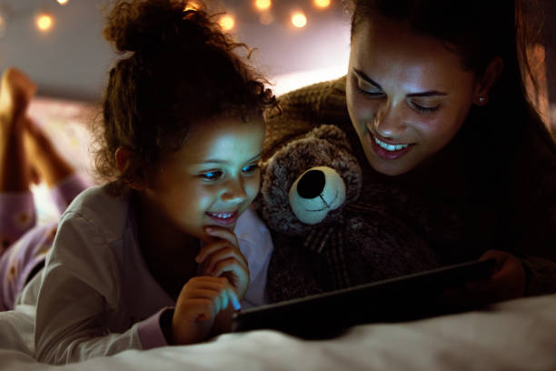 istock Shot of a mother and daughter using a digital tablet before bed time 1326076650