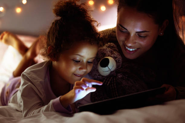 istock Shot of a mother and daughter using a digital tablet before bed time 1326076656