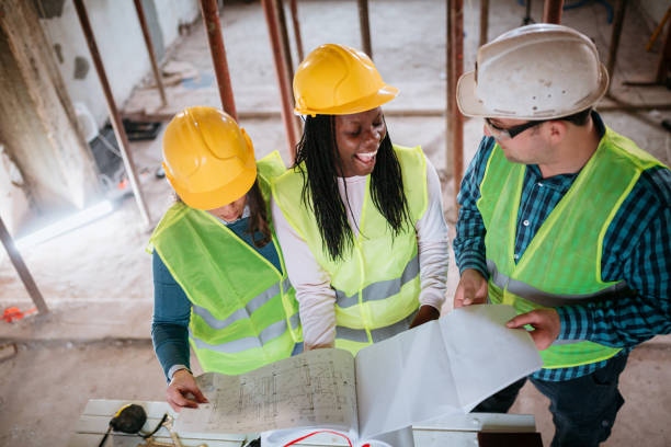 istock Female constructor and female architect reviewing blueprints 1326078344