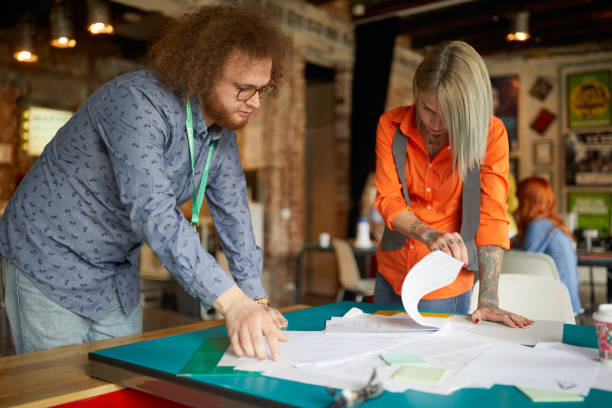 istock Young colleagues in the office are inspecting some project documents 1326079048
