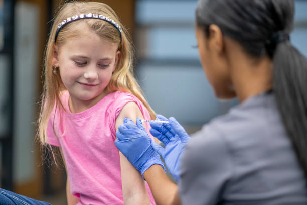 istock Girl gets a shot at doctor's appointment 1326079073
