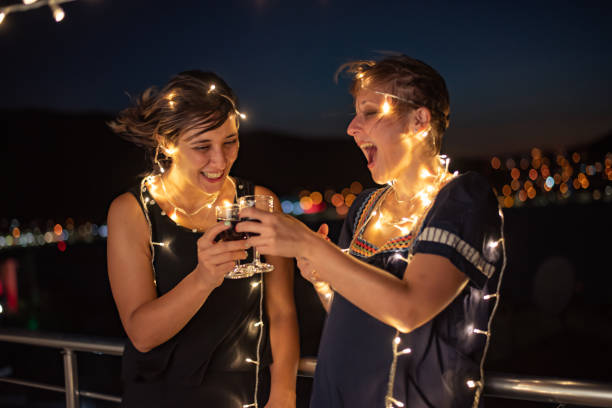istock Two friends enjoying night out at rooftop party 1326079168