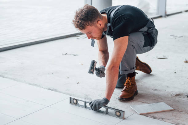 istock Man in grey uniform installing plate indoors in modern big office at daytime 1326080005