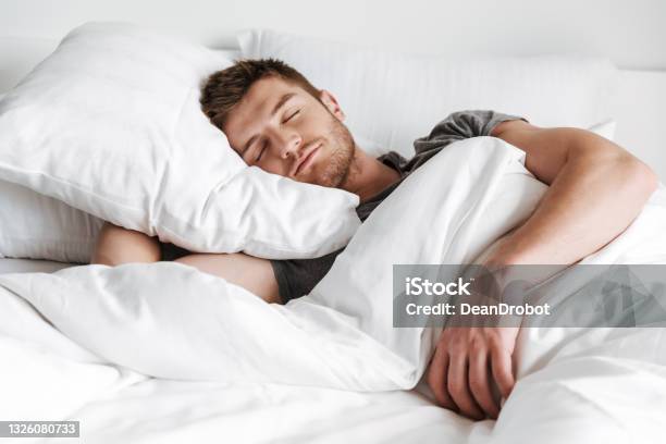 Handsome Young Man Sleeping In Bed Stock Photo - Download Image Now - Sleeping, Men, Bed - Furniture