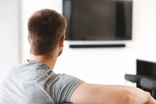 istock Back view of young man sitting 1326080784