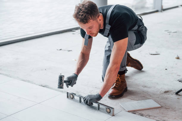 istock Man in grey uniform installing plate indoors in modern big office at daytime 1326081095