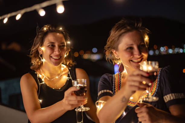 istock Two friends enjoying night out at rooftop party 1326081437
