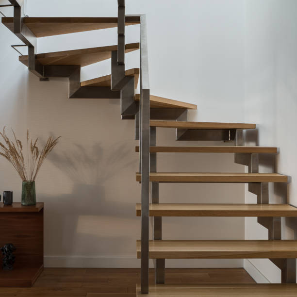 istock Close-up on modern wooden stairs with silver railing 1326081678