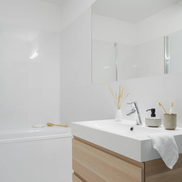 istock Simple bathroom with washbasin with wooden cabinet 1326081749