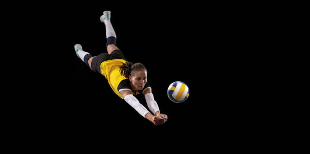 Female professional volleyball player with ball isolated on black studio background. The athlete, exercise, action, sport, healthy lifestyle, training, fitness concept. Game in defense. Female professional fit volleyball player with ball isolated on black studio background. The athlete, exercise, action, sport, training, fitness concept. The girl in motion. the black ball stock pictures, royalty-free photos & images