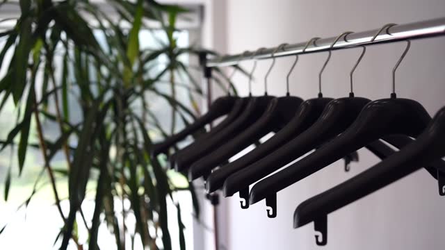Plastic empty clothes hangers on rack