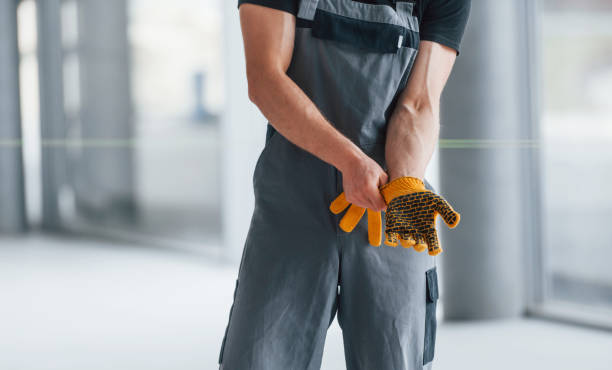 istock Man in grey uniform preparing for work indoors in modern big office at daytime 1326083731
