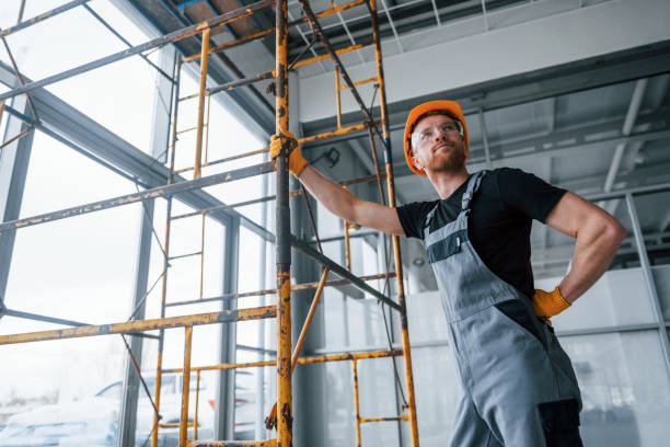 istock Man in grey uniform works with construction indoors in modern big office at daytime 1326084026