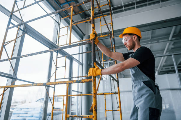 istock Man in grey uniform works with construction indoors in modern big office at daytime 1326084188