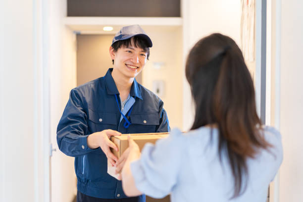 istock Young woman receiving a parcel delivery 1326084718