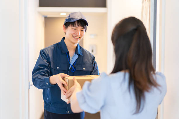 istock Young woman receiving a parcel delivery 1326084720