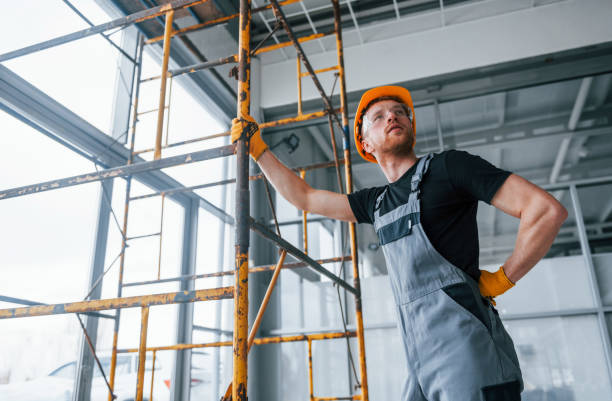 istock Man in grey uniform works with construction indoors in modern big office at daytime 1326084728