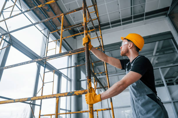 istock Man in grey uniform works with construction indoors in modern big office at daytime 1326084904
