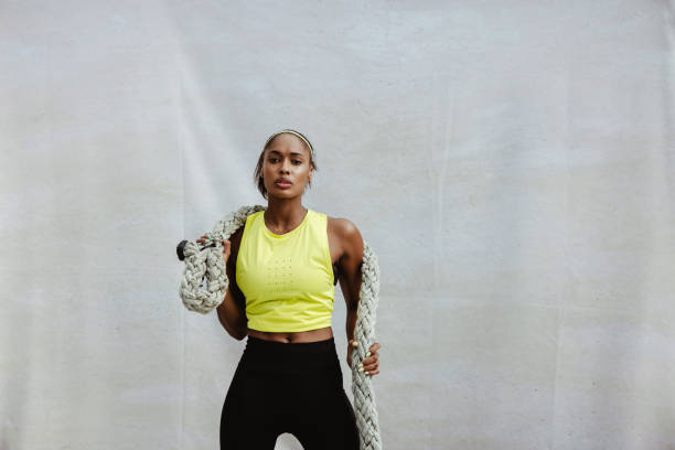 istock Sportswoman doing battle rope workout 1326085441