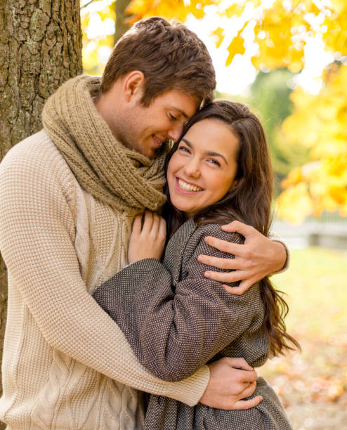 istock smiling couple hugging in autumn park 1326085487